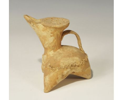 An undated archaistic Amlash terracotta jug with three conical legs, domed body, funicular head with plaited strap handle to 