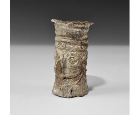 1300-1500 AD. A Chimu culture sheet-silver face-beaker or kero, depicting a hook-nosed male face with avian qualities, lentoi