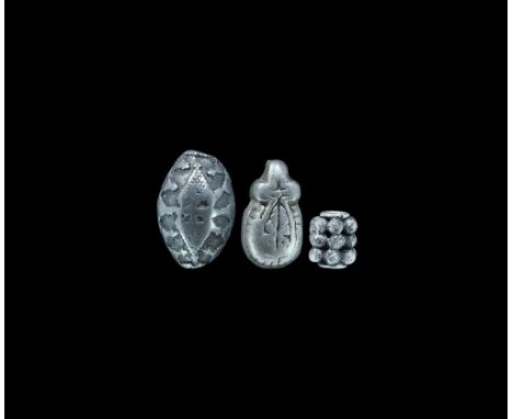11th-14th century AD. A mixed group of silver Viking and later mounts comprising: a tubular bead with granules; a lozenge-sha