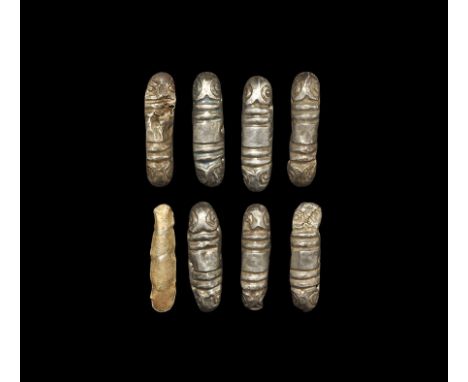 9th-11th century AD. A group of seven D-section silver fusiform mounts, each with beast-head finial and ribbed collars, pierc