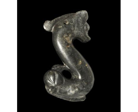 An undated archaistic black hardstone pendant, s-curved in profile with feline head to the upper finial and gryphon to the lo