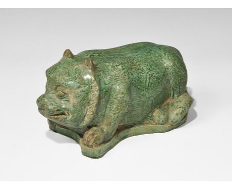 An undated archaistic green-glazed ceramic figurine of a crouching bear on an irregular base, hollow to the underside. 2.2 kg