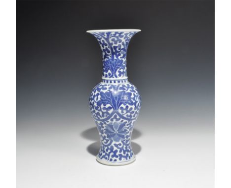 20th century AD. A white-glazed ceramic piriform vase with flared rim, blue floral and foliage motifs. 978 grams, 29cm (11 1/