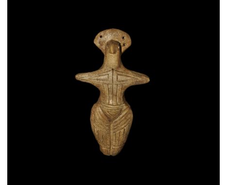 An undated archaistic ceramic figurine with incised linear detail to the body and legs, pierced crescent headdress, mounting 