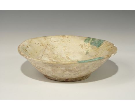 12th-14th century AD. A group of two white-glazed ceramic bowls with green strokes to the inner face, one with chevron design