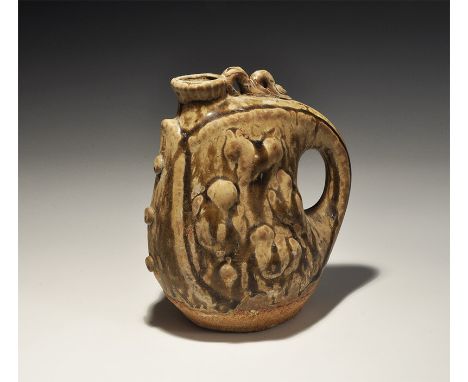 An undated archaistic ceramic jar with broad spout and integral loop handle, applied scroll detailing, olive glaze. 618 grams