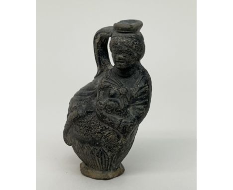 Egypt, black earthenware figure flask, Ptolemaic, 1st century BC - 1st AD., in the shape of a seated woman holding a goose. P