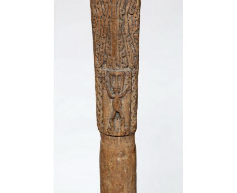 Papua, Cenderawasih Bay, axe shaft, early 20th cent., The top deep-relief carving and a rectangular cartouche in low relief s