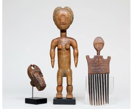 Ghana, Akan, a standing female shrine figure, a comb and a Ivory Coast, miniature buffalo mask. h. 32,5 L. 24,5 and 10,4 cm. 