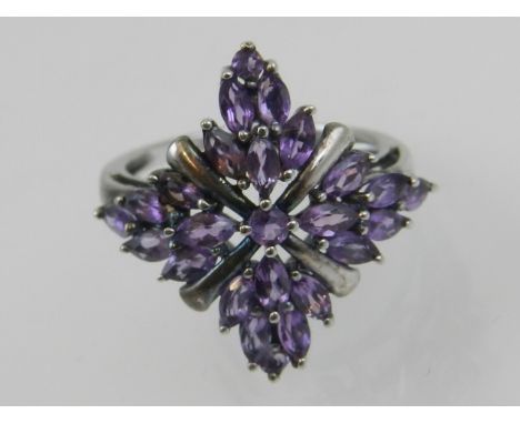 A silver and amethyst set symmetrical cluster ring, set marquise and round cut amethysts. 