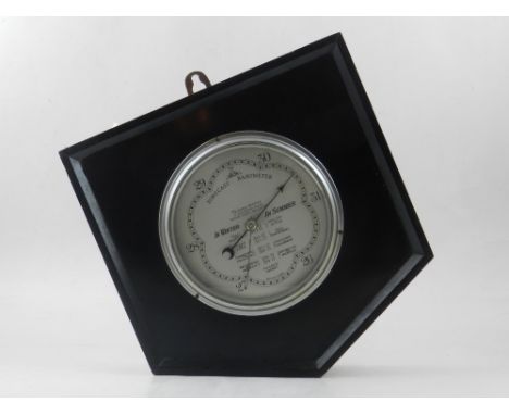 A forecast barometer, with silvered round dial and ebonised case. 