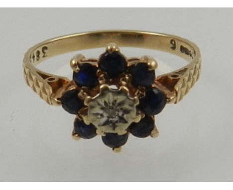 A 9 carat yellow gold, sapphire, and diamond floral cluster ring. 