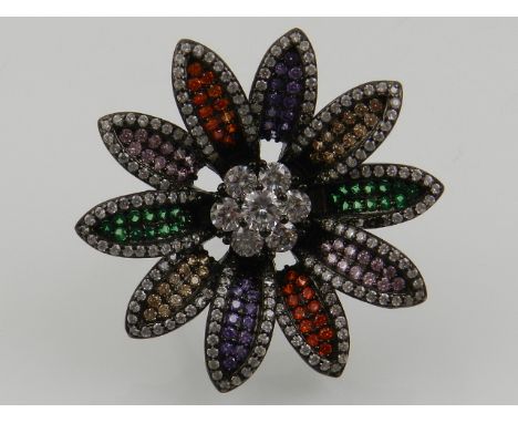 A silver and multi-coloured cubic zirconia set floral cocktail ring. 