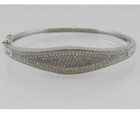 A silver and cubic zirconia set bangle. 