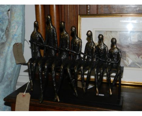 After Giacometti, a figural study of seven people sitting on a bench.