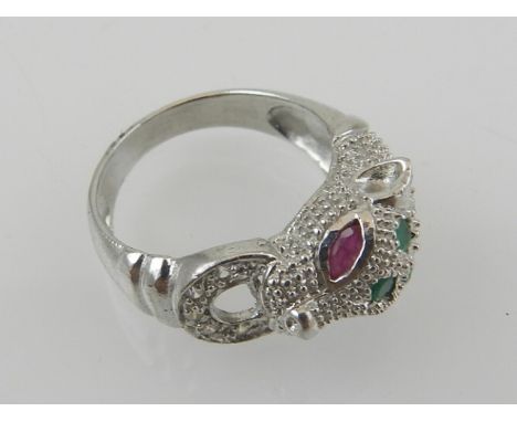 A silver, cubic zirconia, ruby, and emerald set ring, in the Cartier style, in the form of a panther.