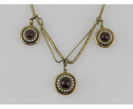 A late 19th / early 20th century yellow metal, garnet, and enamel necklace, in the Georgian  taste, suspended three round pen