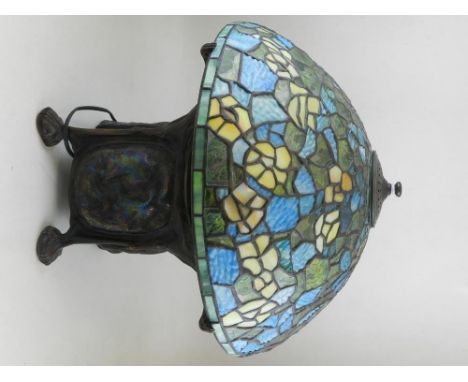 A TIffany style table lamp, having coloured leaded glass shade, above a naturalistic metal base, approx H:45cm