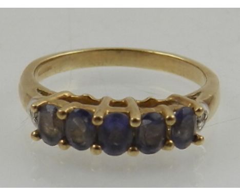 An unusual 9 carat yellow gold and blue amethyst five stone ring. 