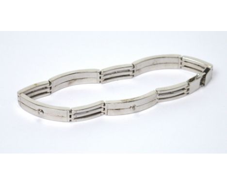 A 9ct white gold gentlemen's bracelet, four panels set with rub-over set diamonds, alternated with gate links, approx 26.7g. 