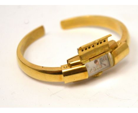 A Bucherer ladies' 18ct yellow gold adjustable bangle watch, cover set with seven diamonds and foliate engraved decoration, w