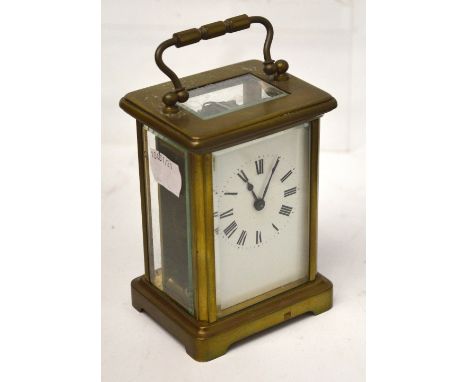An early 20th century French brass-cased carriage clock, white enamel dial set with Roman numerals, height 11cm.