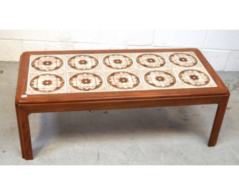 A c1960/70s rectangular teak coffee table inset with floral ceramic tiles, 110 x 51cm and a rectangular bevel-edge wall mirro