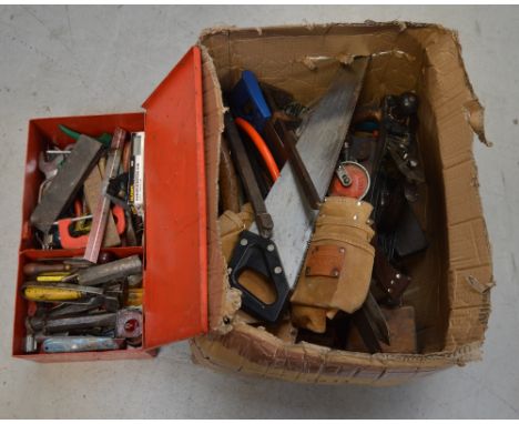A large quantity of tools part-contained within a red-painted toolbox, to include planes, chisels and saws.