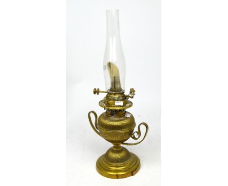 An early 20th century brass oil lamp in the form of a Grecian urn.