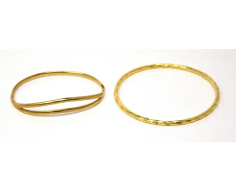 A 9ct yellow gold bangle and an 18ct yellow gold bangle, approx combined 8.4g (2).