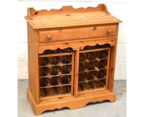 A 20th century pine single-drawer wine cabinet raised on bracket feet, width 72cm.