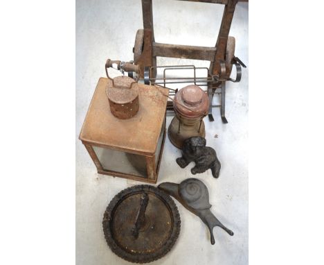 A large square lantern and a smaller example, a boot scraper, a vintage wooden porters' trolley, a cast iron doorstop in the 