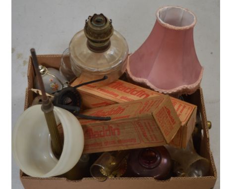 A quantity of oil lamps, parts and fittings and a glass and marble-effect table lamp.