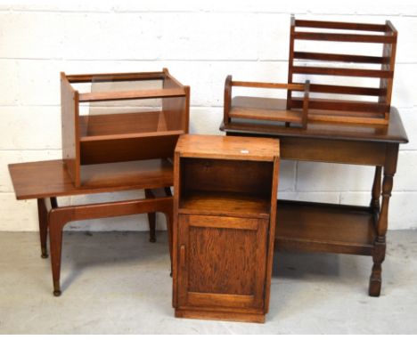 A priory-style oak table on turned supports, two vintage magazine racks, a small oak drop-leaf side table with lower shelf, a