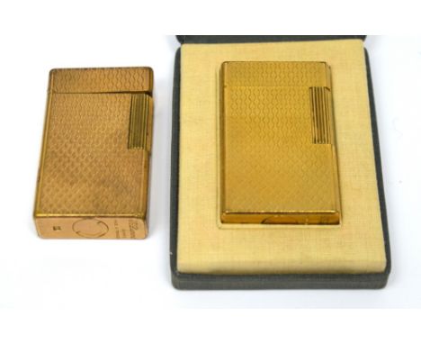 A cased Dupont engine-turned gilt lighter, code M3BE37 and further uncased example, code M3BE41 (2).