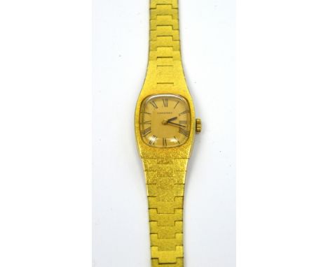 Longines; a c1960s ladies' wristwatch, gold-filled case and integral band with stainless steel back, gold-coloured cushion di