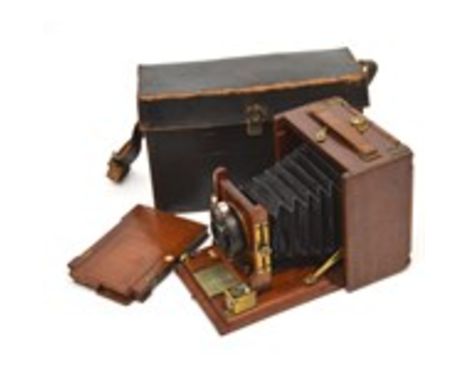 Ilex Optical Co; a mahogany brass-mounted folding plate camera with spare plates, in a fitted case.