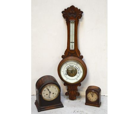 A carved oak wall barometer, height 86cm and two oak-cased mantel clocks, one with silvered dial and barleytwist supports (3)