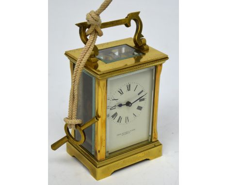 Thomas Russell & Son of Liverpool; a carriage clock in a lacquered brass case, five bevelled glass display panels, circular d