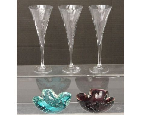 Two Whitefriars coloured glass ashtrays with encapsulated bubble decoration and a set of three Orrefors crystal wine glasses 