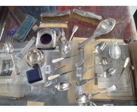 A quantity of hallmarked silver items to include a hallmarked silver watch case, three small silver brushes, a set of six tea