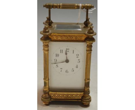 An early 20th century lacquered brass cased carriage clock having white enamel dial with Arabic numerals and visible platform