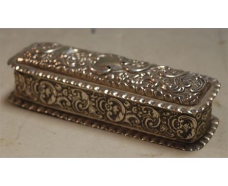 A circa 1900 silver *DRESSING TABLE TIDY* and cover of rectangular form with all over embossed C-scroll decoration