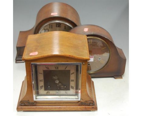 An Art Deco walnut cased mantel clock; together with two other oak cased examples (3)