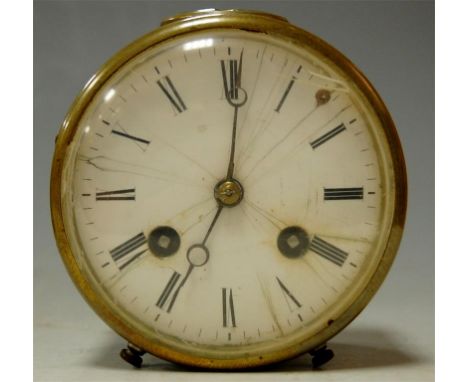 A circa 1900 brass cased drum shaped mantel clock having an enamel dial with Roman numerals, 8 day cylinder movement and visi