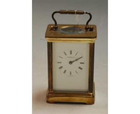 A mid 20th century lacquered brass cased carriage clock, the white enamel dial with Roman numerals signed Sanders & Co. havin