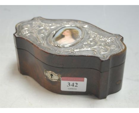 A late 19th century walnut and white metal mounted trinket jar and cover, of oval serpentine form, having inset porcelain por