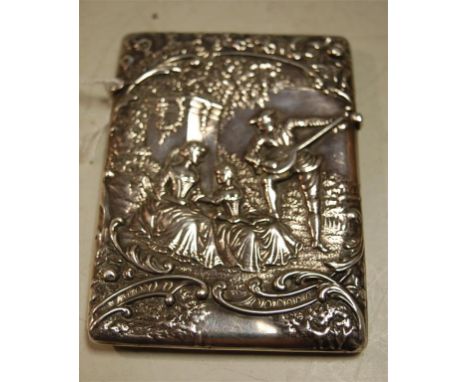 A late Victorian silver visiting card case, having embossed decoration depicting a musician with attendant ladies, with lands