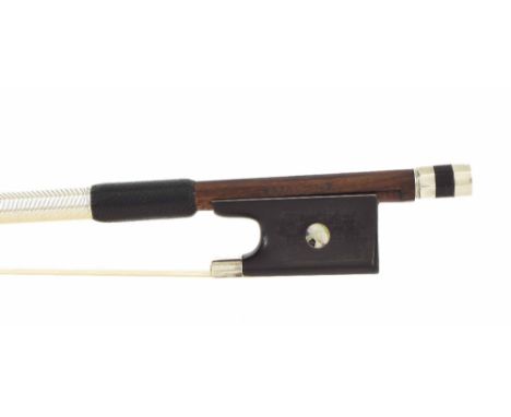 Silver mounted violin bow stamped Hawkes & Son, the stick round, the ebony frog inlaid with pearl eyes and the ebony adjuster