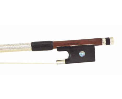 Silver mounted violin bow stamped N. Vuillaume, the stick round, the ebony frog inlaid with pearl eyes and the ebony adjuster